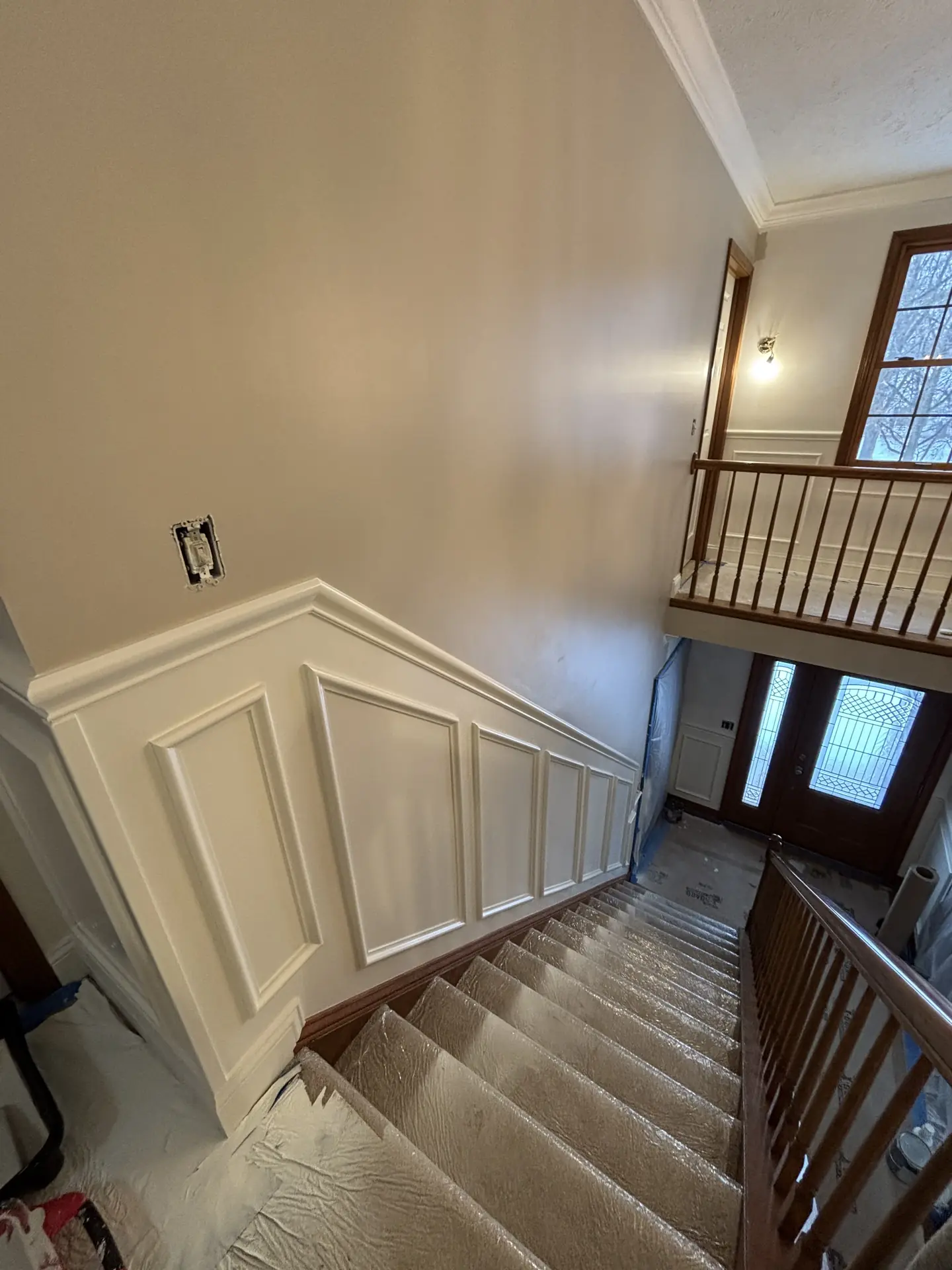 Foyer mid-renovation with fresh paint